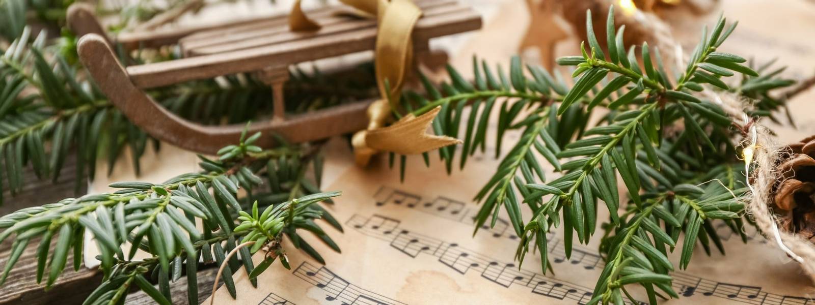 Christmas composition with music notes on wooden table