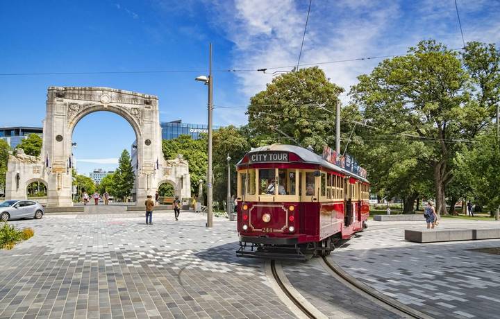 3 January 2019: Christchurch, New Zealand - A vintage tram turns into Cashel Street near the Bridge of Remembrance in the ce…