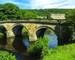 Stone road bridge over the River Derwent at Chatsworth house estate, Derbyshire.