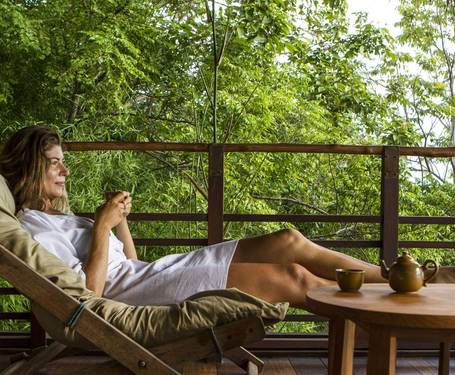 Woman sitting down and relaxing, looking at views on a Winter Wellness retreat