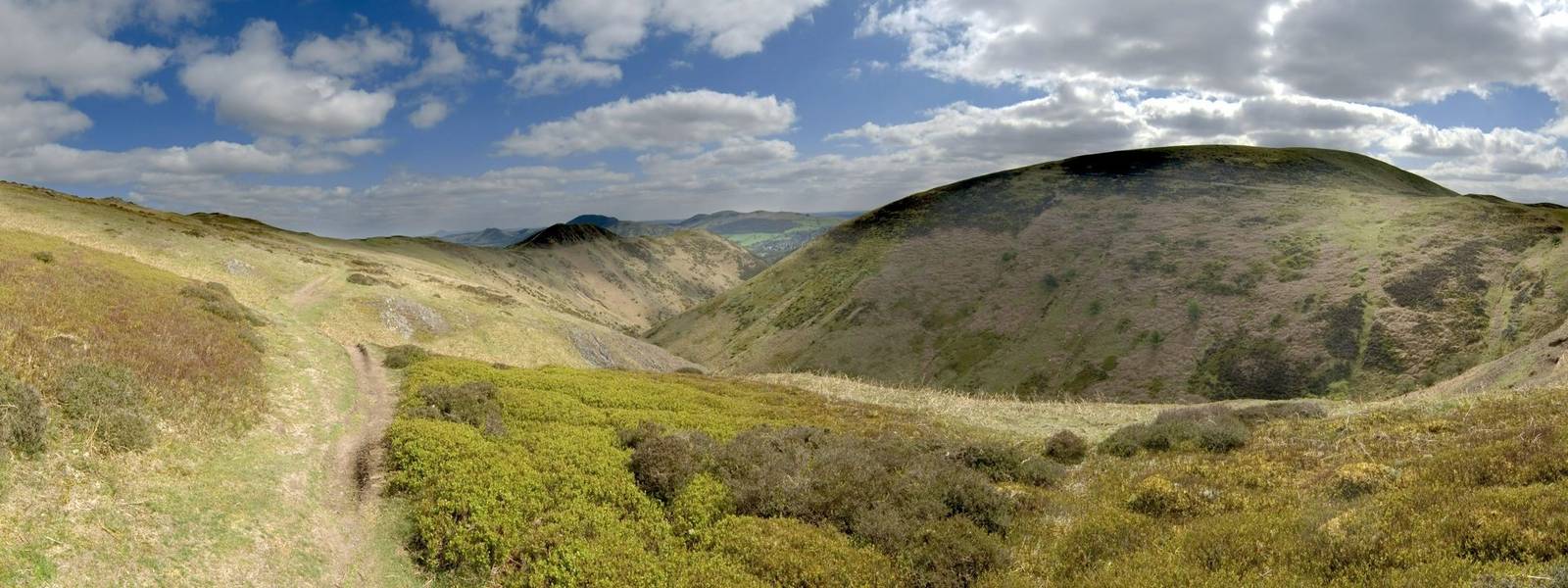 sunlit footpath and moody clouds long mynd church stretton shropshire