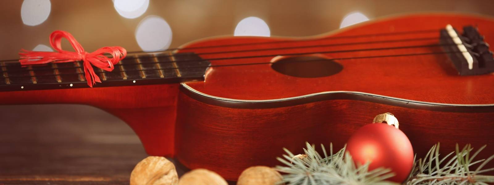 Christmas music concept. Ukulele with decoration on wooden table