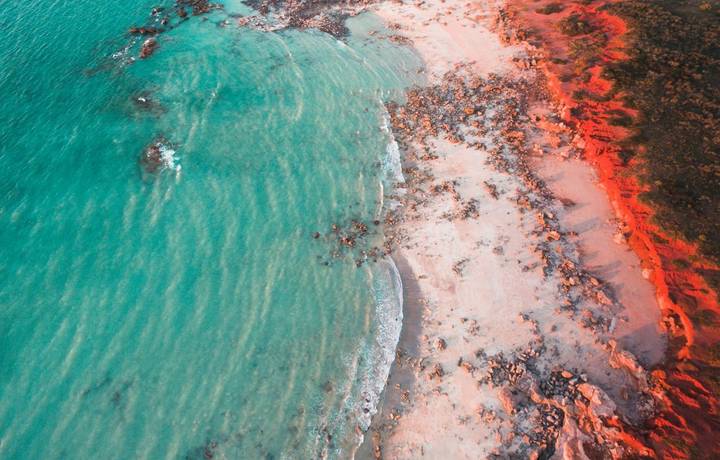 An aerial view of Gantheaume Point in Broome, Western Australia at golden hour just before sunset, with the sun lighting the… An aerial view of Gantheaume Point in Broome, Western Australia at golden hour just before sunset, with the sun lighting the…