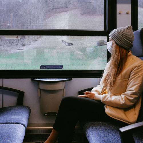 Woman wearing mask on train