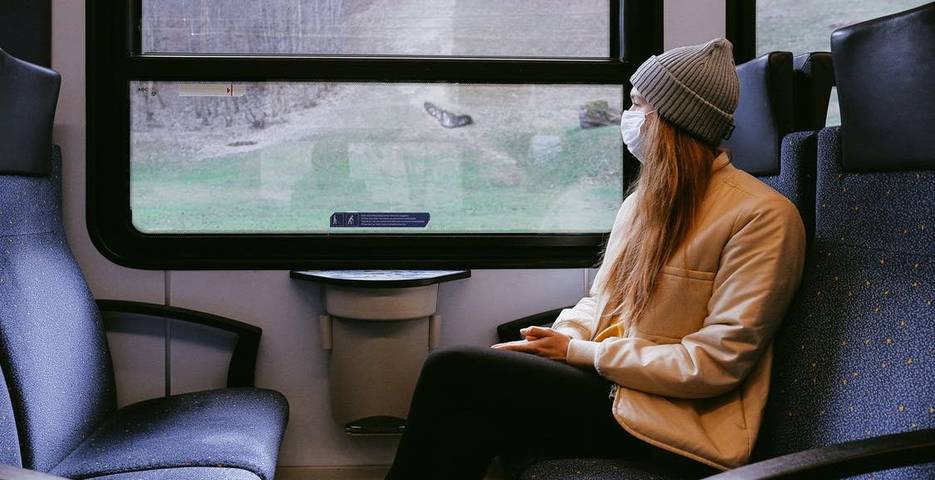 Woman wearing mask on train