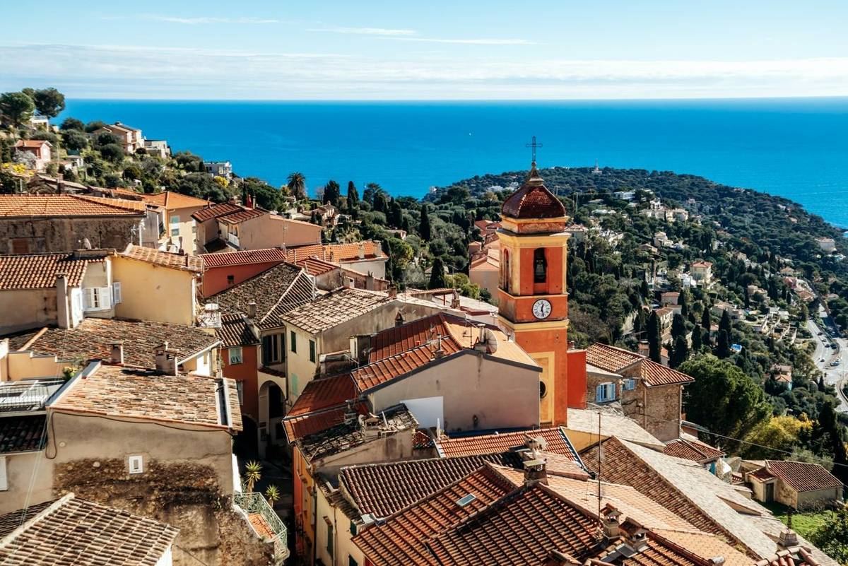 Panoramic view of Roquebrune village rooftops with Sainte Marguerite church bell tower and Cap Martin peninsula