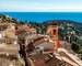 Panoramic view of Roquebrune village rooftops with Sainte Marguerite church bell tower and Cap Martin peninsula