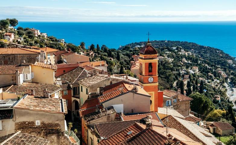 Panoramic view of Roquebrune village rooftops with Sainte Marguerite church bell tower and Cap Martin peninsula