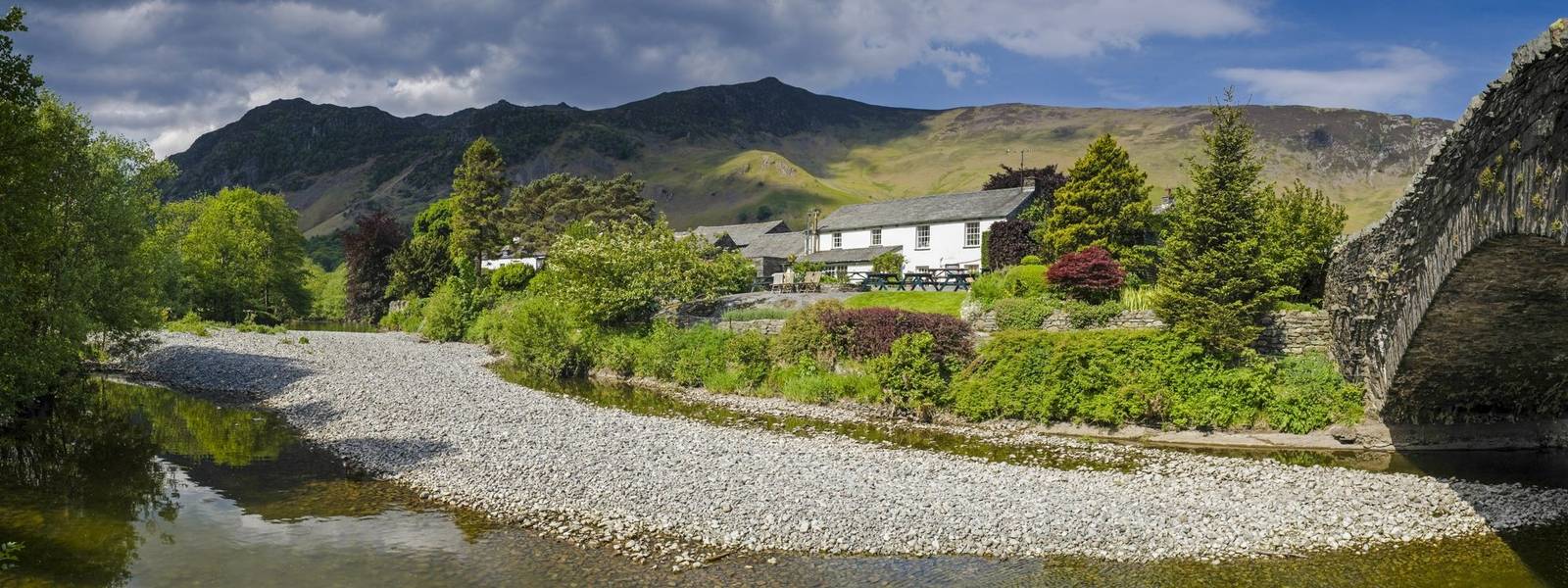 Mountains and dry stone bridge in Cumbria UK.