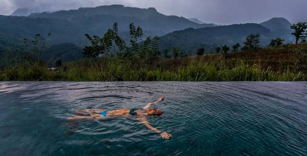 Woman floating in the pool at Santani Wellness Resort and Spa