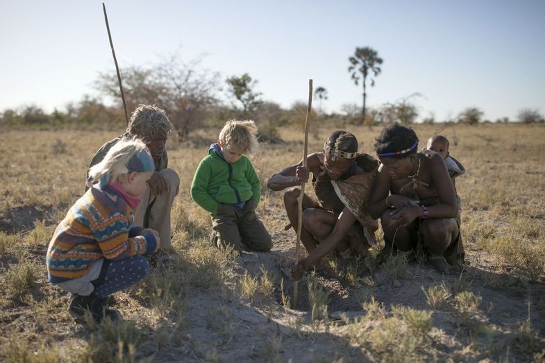 African Travel Inc - Platinum Botswana - Jack's Camp_Bushmen experience family - Kids with the bushmen.jpg
