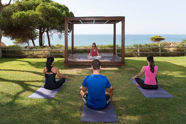 Group doing yoga at Pine Cliffs Resort