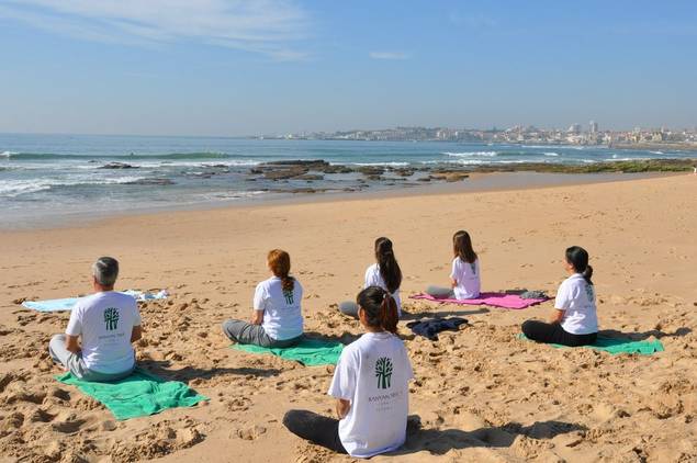 Group beach yoga at Palacio Estoril