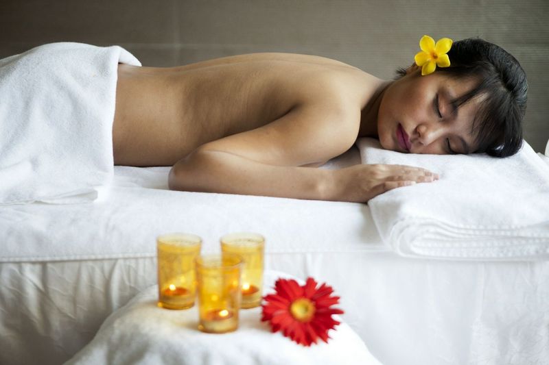 Woman getting floral massage at Atmantan Wellness