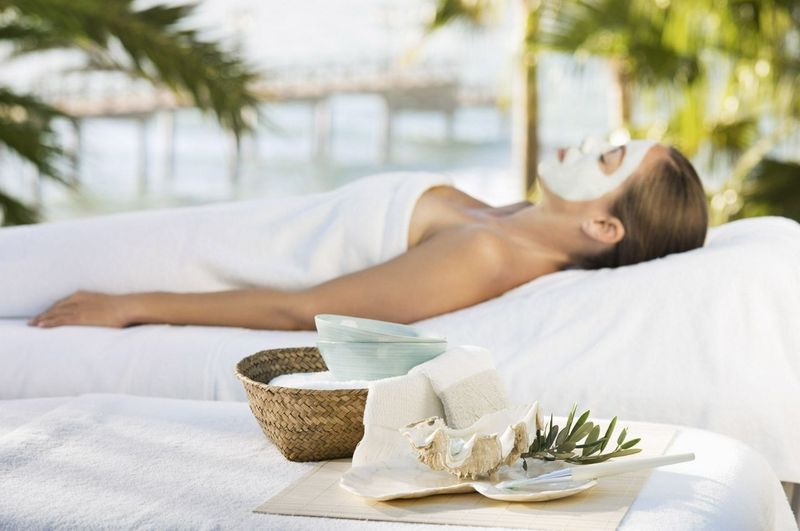 Woman relaxing on a sun lounger with a face mask on