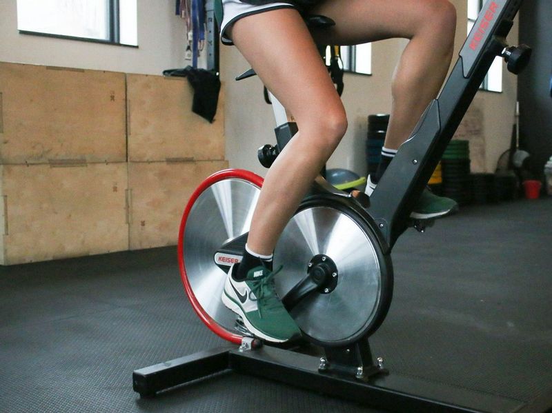 person training on a spinning bike