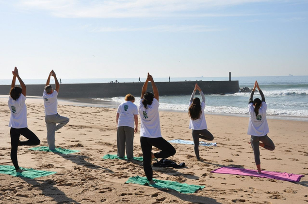 group yoga on beach at Palacio Estoril