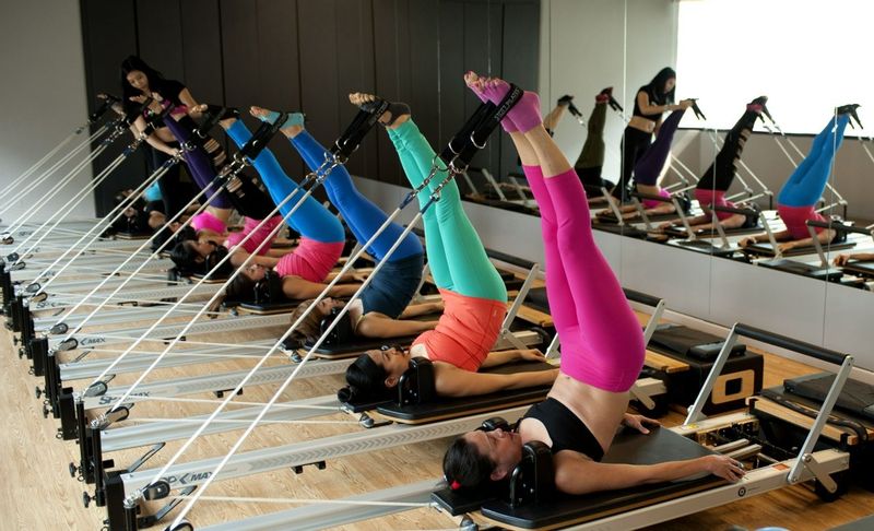 Women practicing reformer Pilates at Absolute Sanctuary